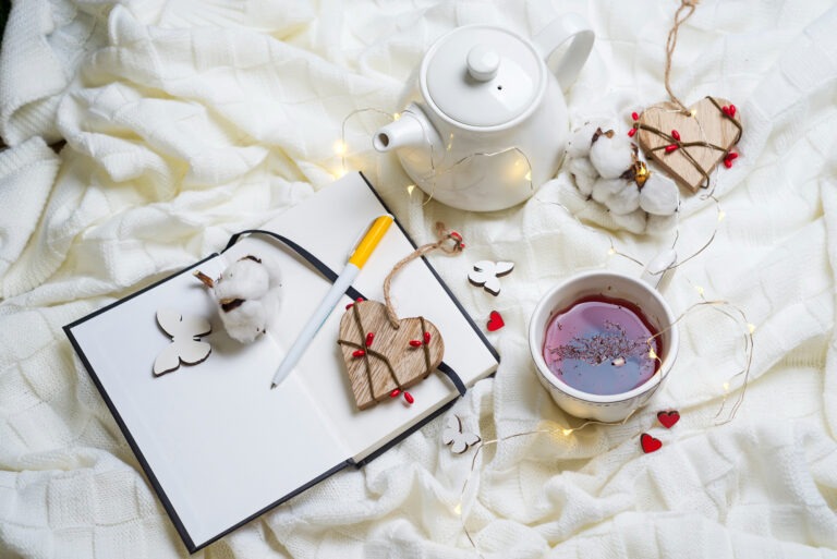 Bedtime routine flat lay journal herbal tea sleep mask