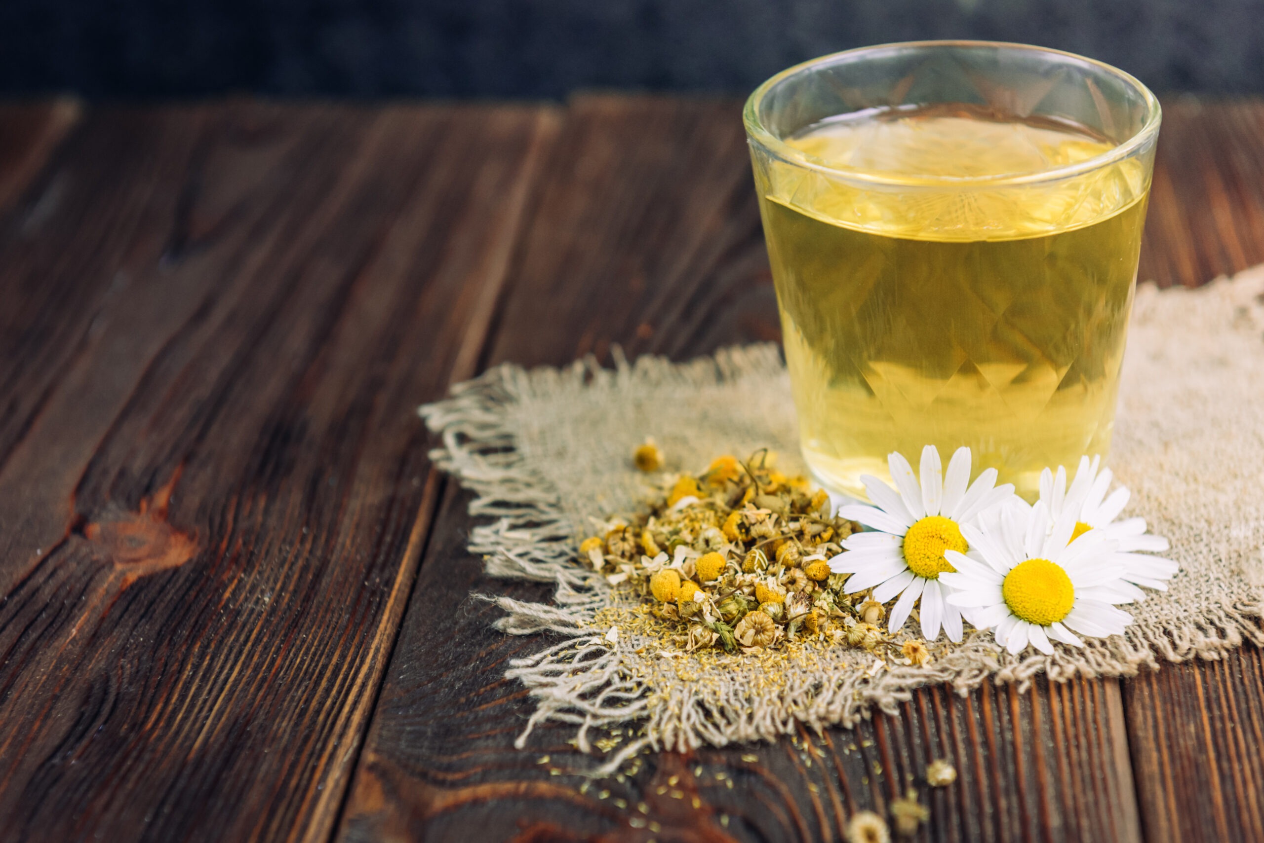 Warm chamomile tea on a wooden surface in a cozy early morning atmosphere